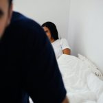 woman lying on bed in room