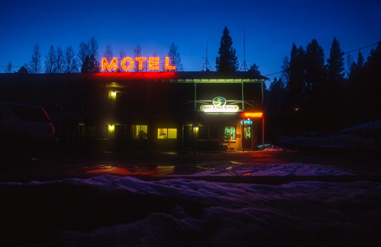 a motel lit up at night in the snow